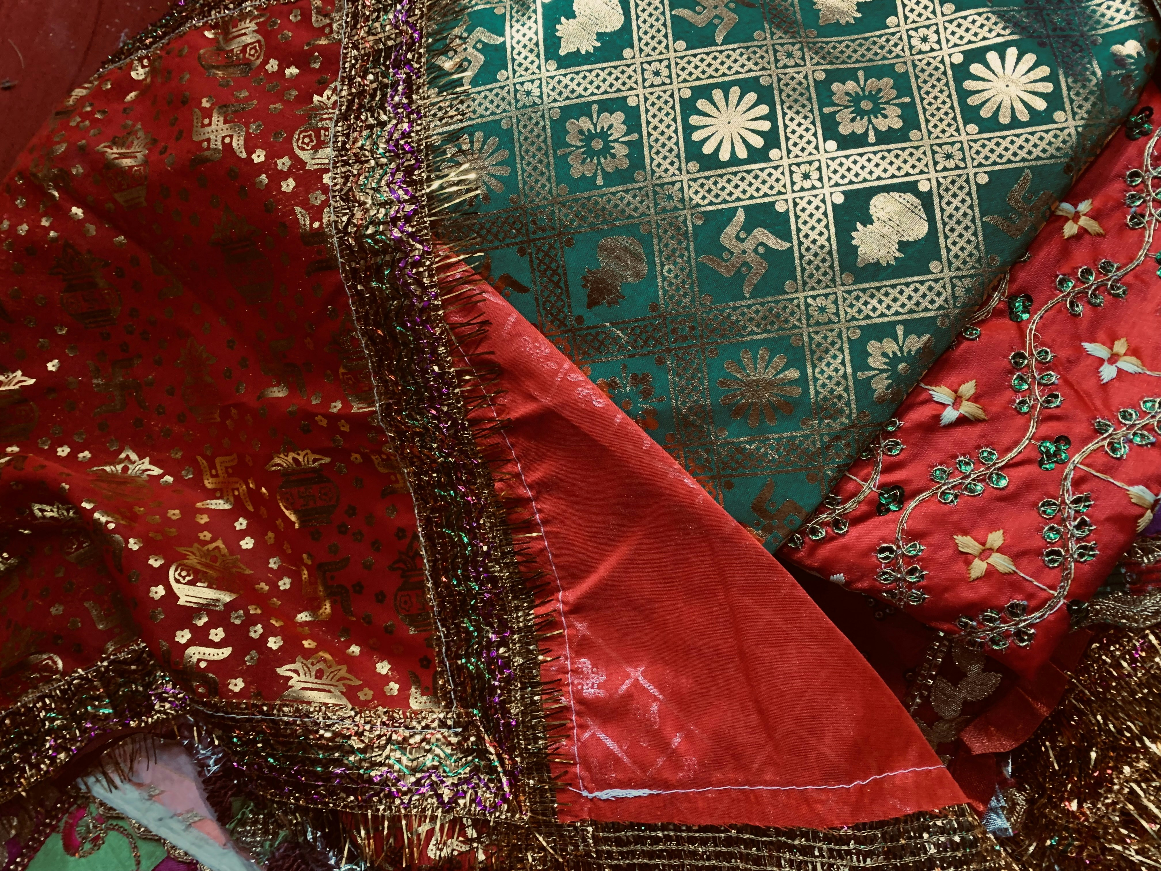 Vibrant Ankara fabric with bold African patterns in gold, red, and green colors