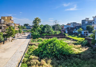 Spacious plot with greenery in Uppal area under clear blue sky.