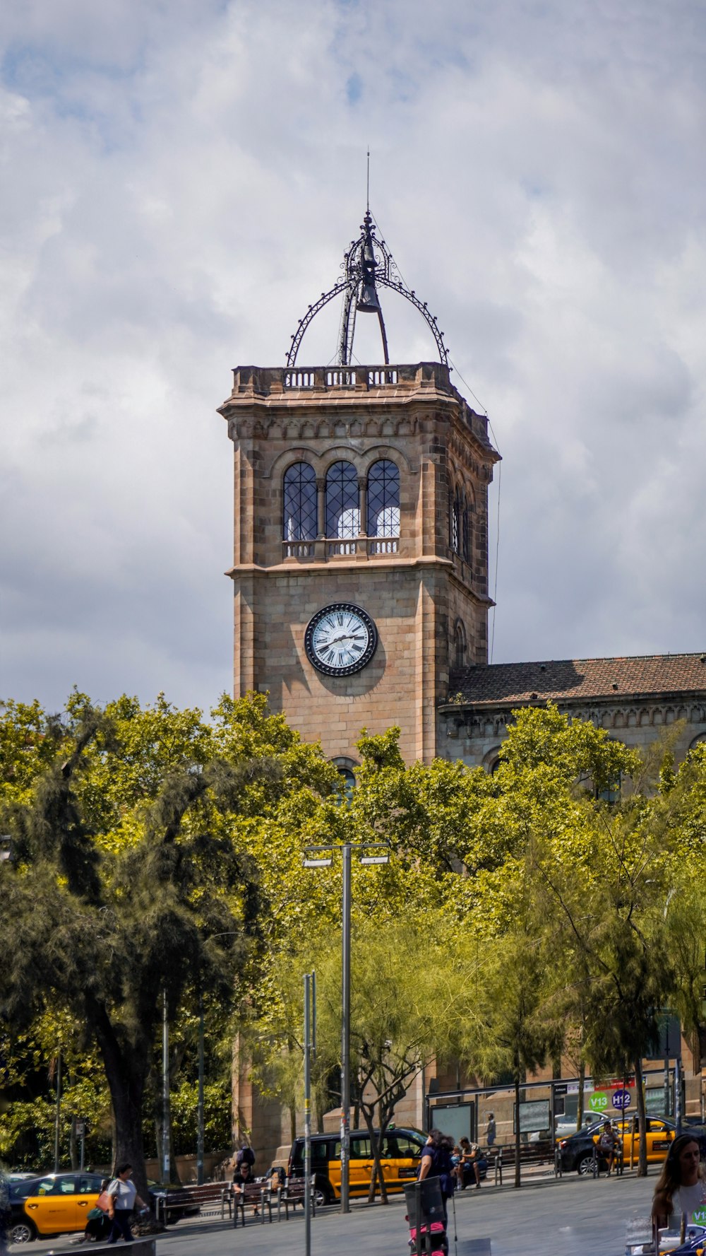 a clock tower with a weather vane