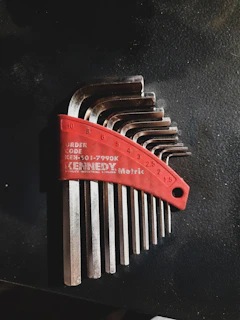 A set of polished spanners laid out in ascending size order on a workbench.