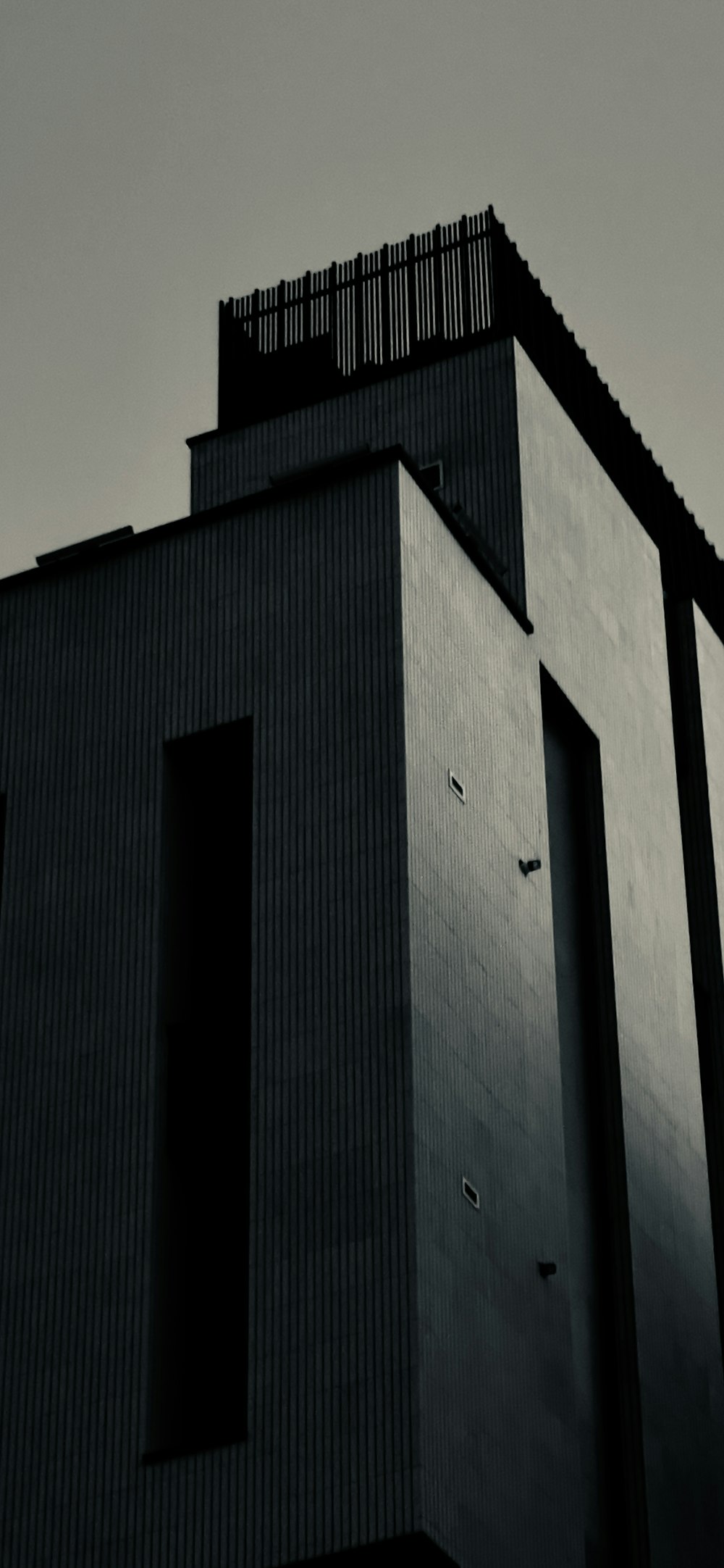 a tall building with a black roof