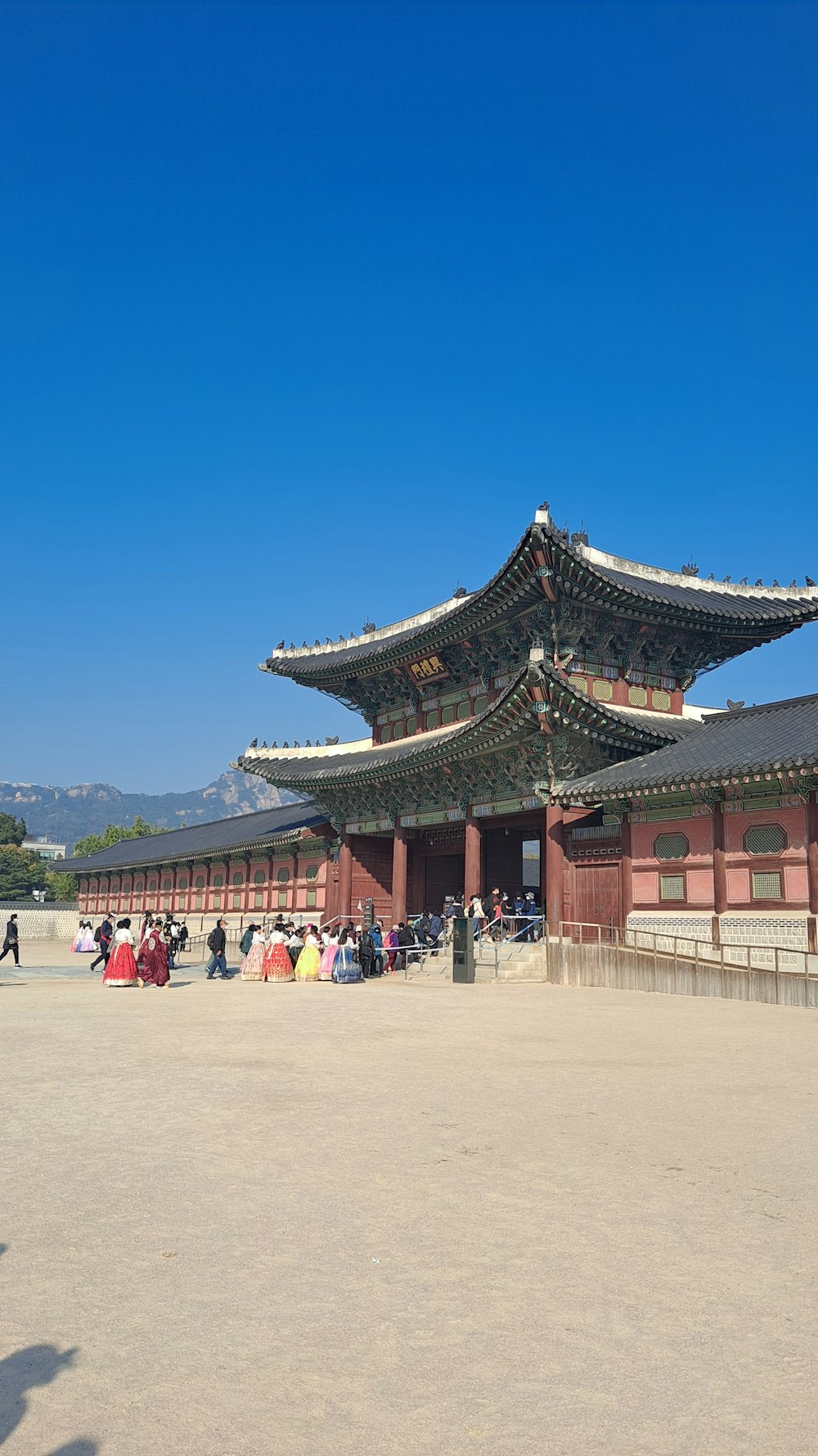 a group of people standing outside Gyeongbokgung