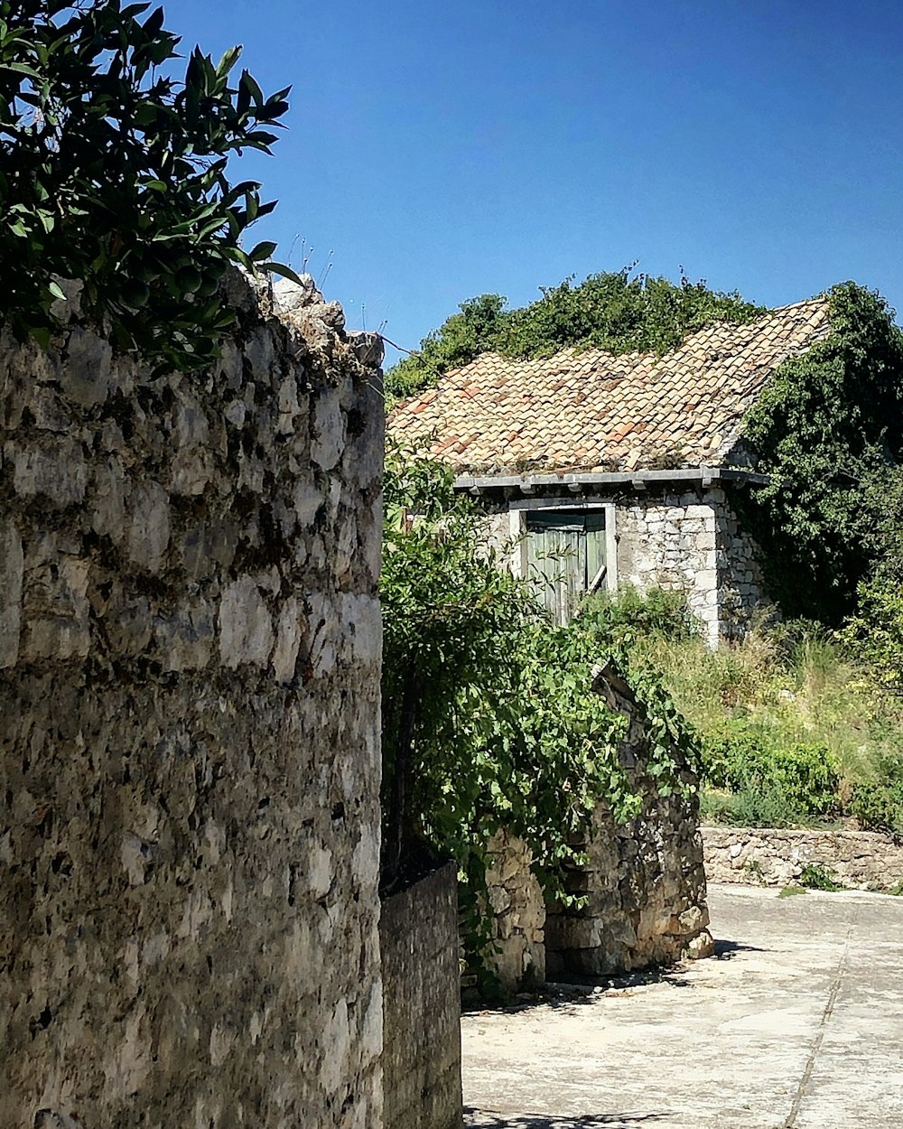 a stone building with a grass roof