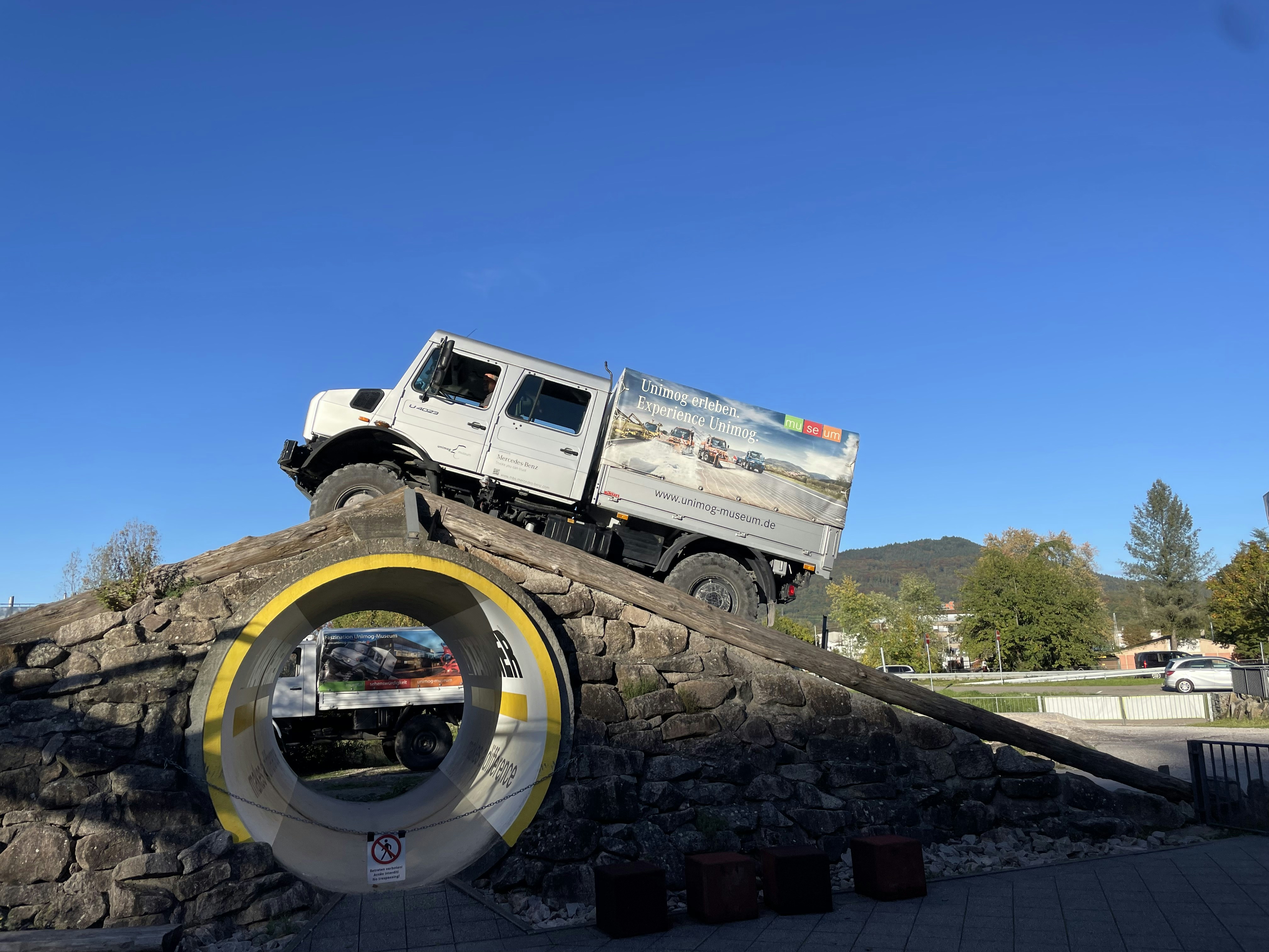 a white truck on a rock wall