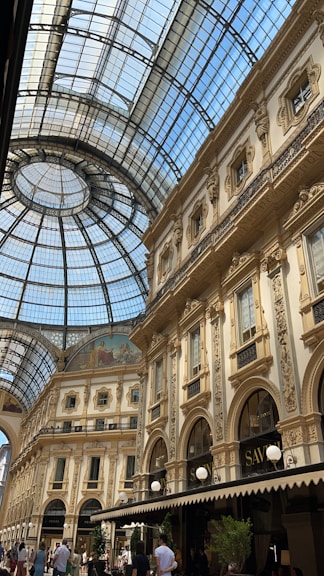 a large building with a glass ceiling with Galleria Vittorio Emanuele II in the background