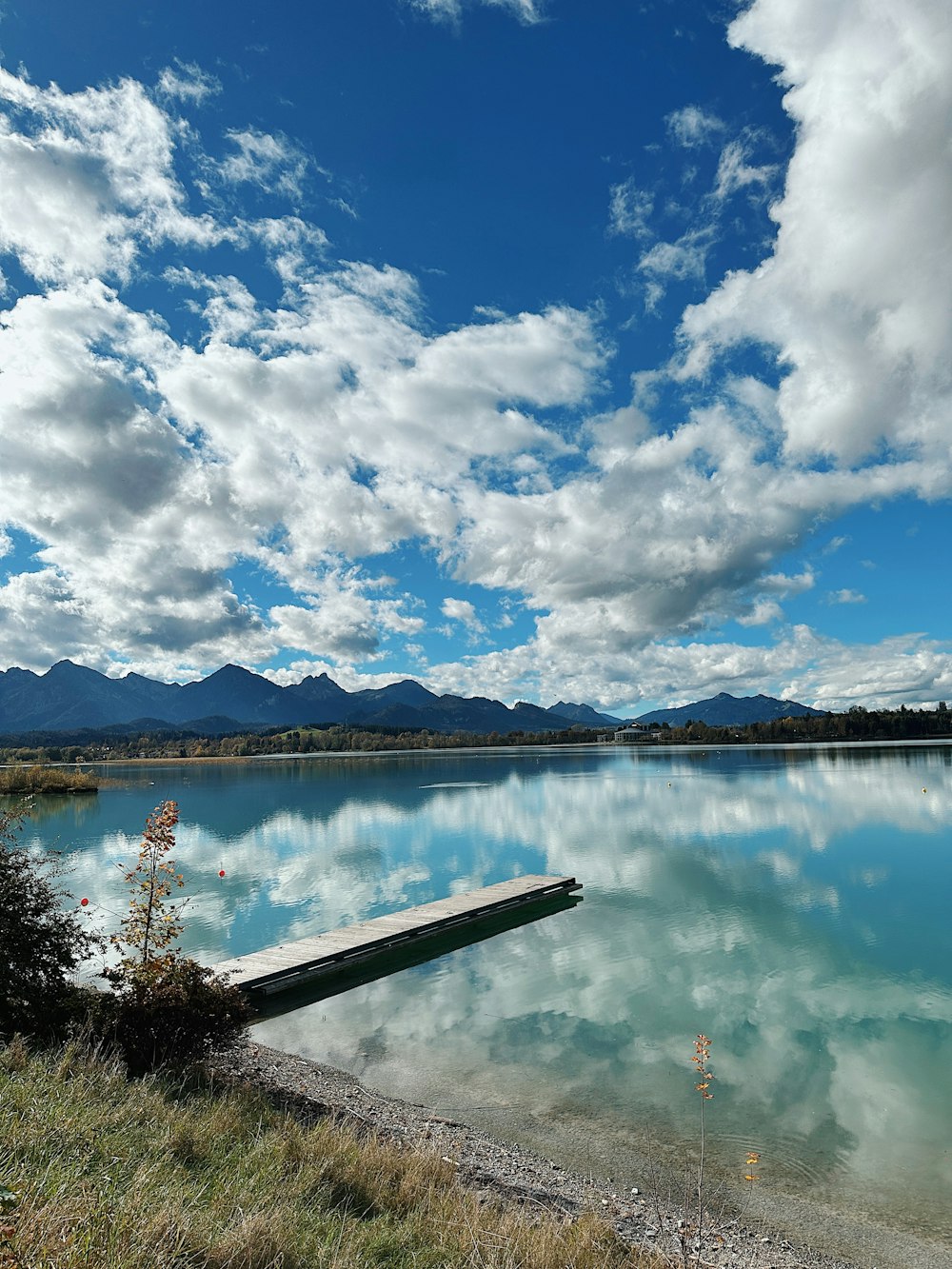 a body of water with mountains in the background