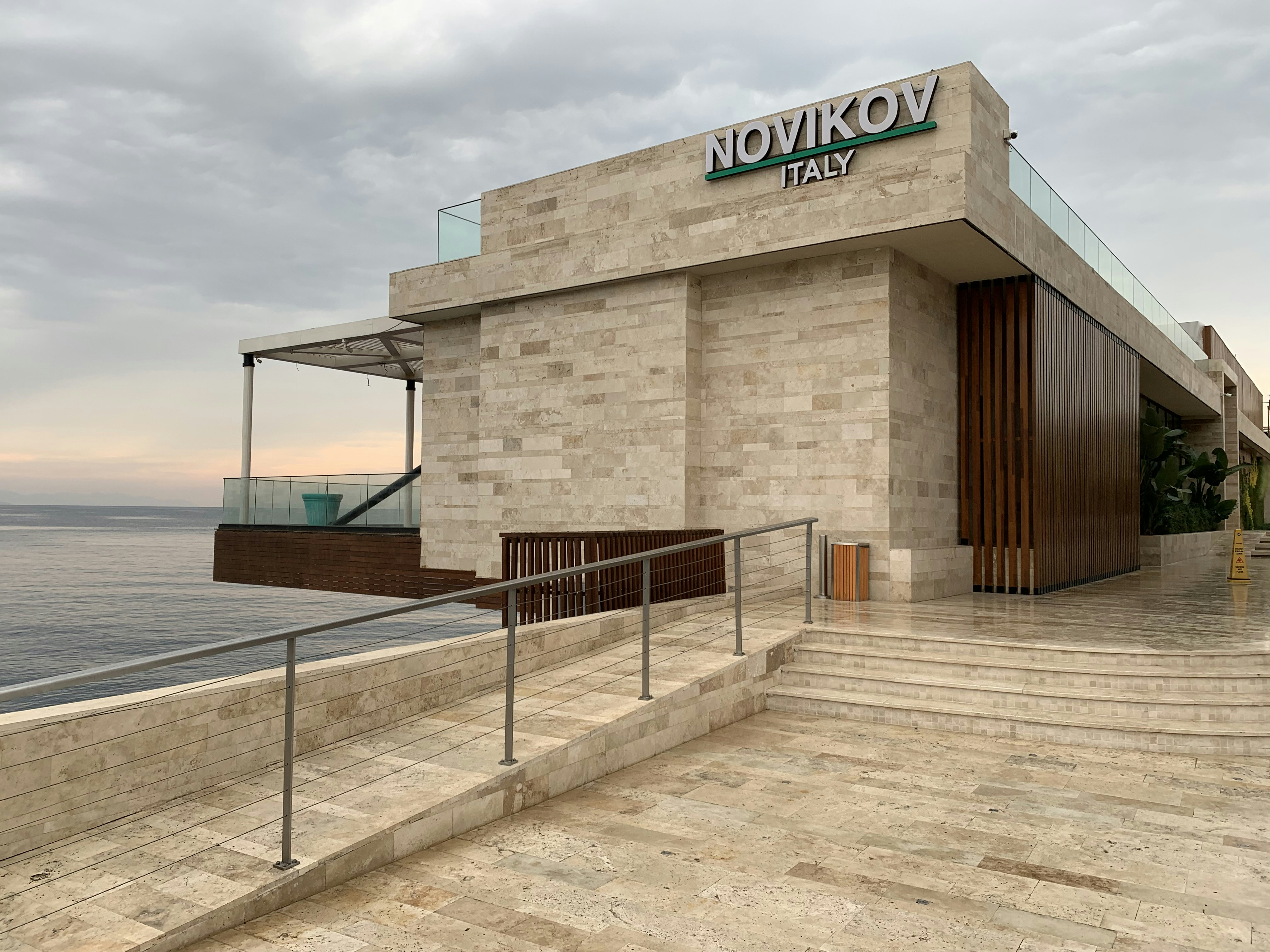 a building with a sign on it by the water