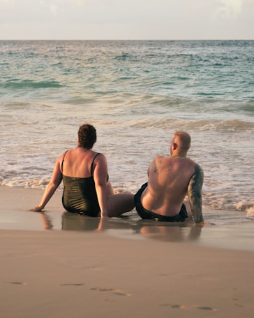 Couple sitting on beach talking about anxiety therapy in Hawaii