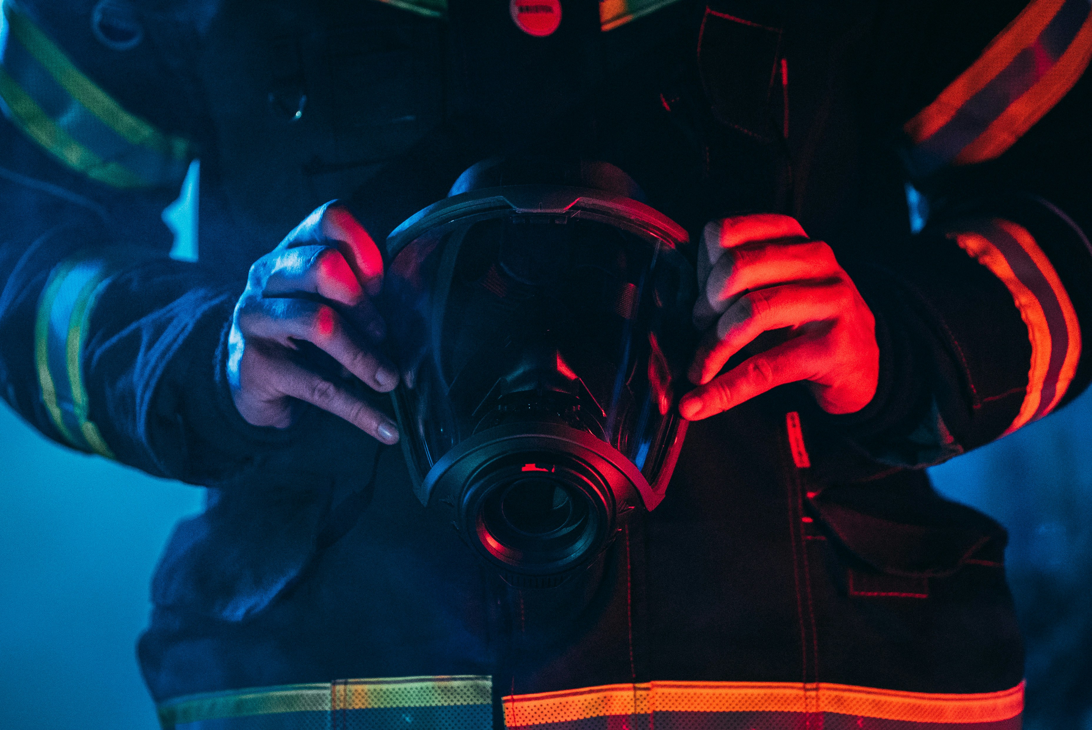 A firefighter holding a mask.
