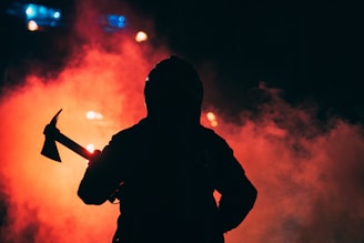 a person with a microphone and a fire in the background