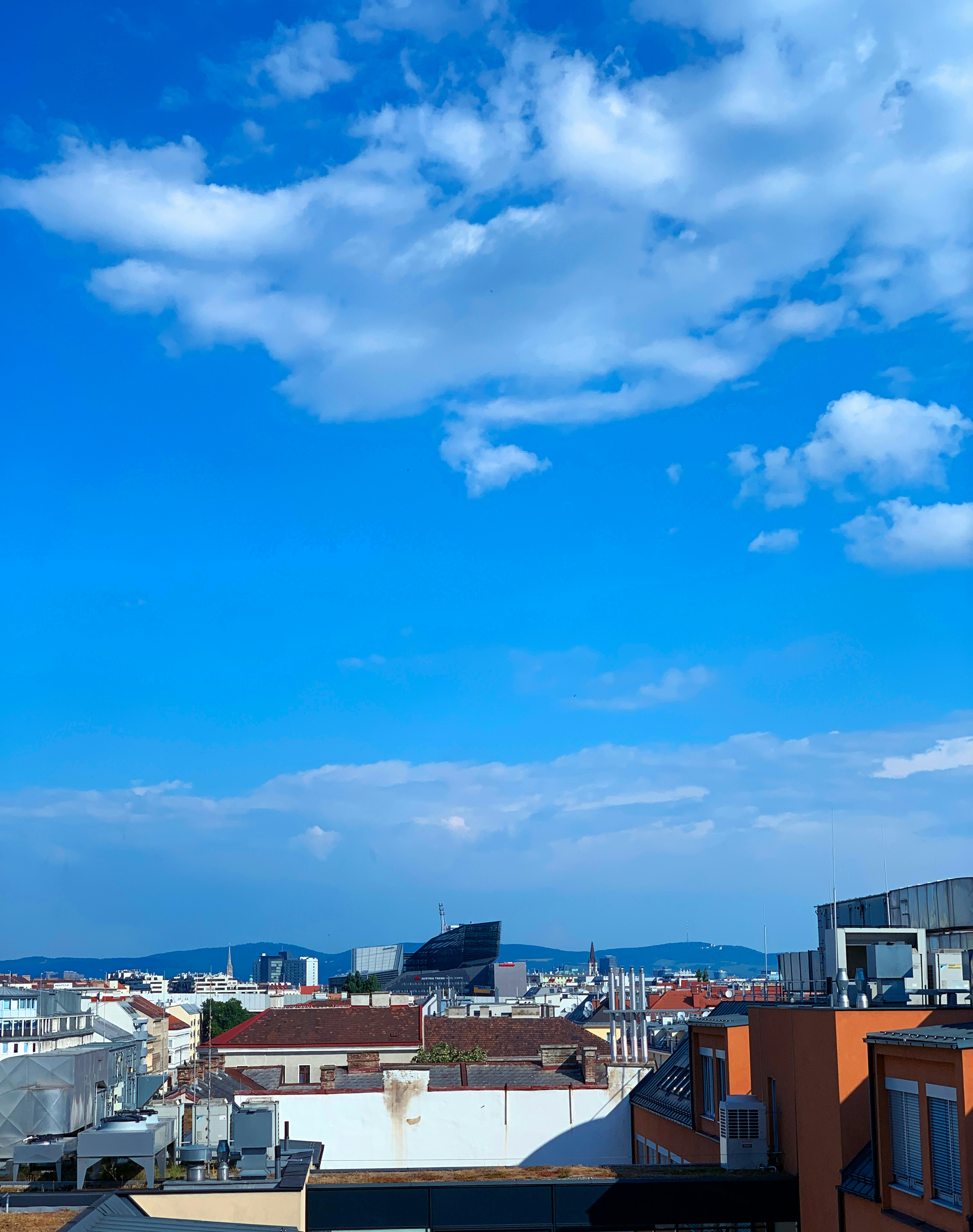 a city with blue sky and clouds