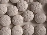 A variety of uniquely shaped fentanyl pills showcasing different monograms.