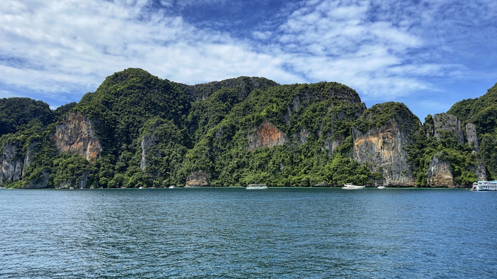 a body of water with a rocky island in the middle