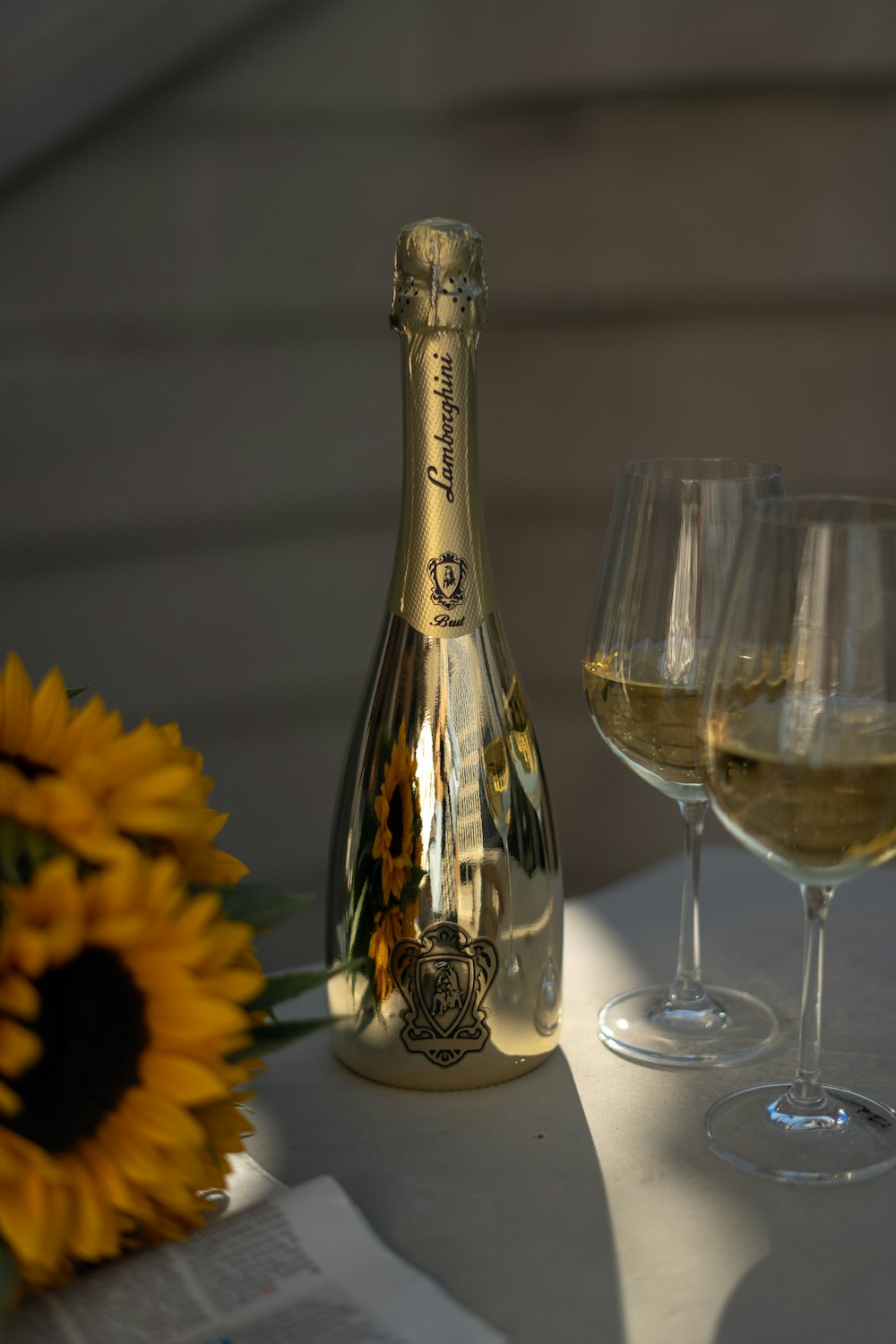 a bottle of champagne next to several wine glasses