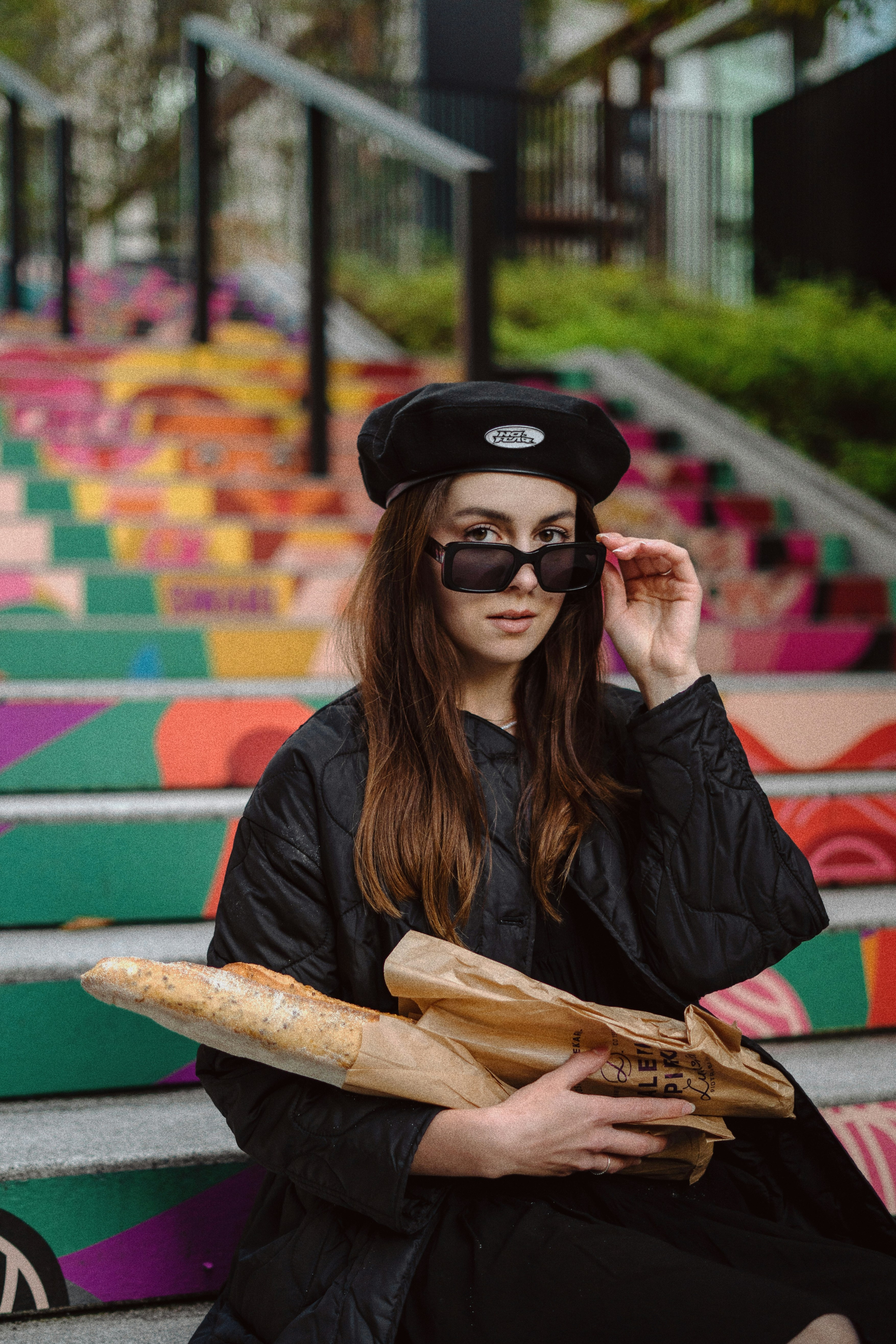 woman with sunglasses carrying baguette