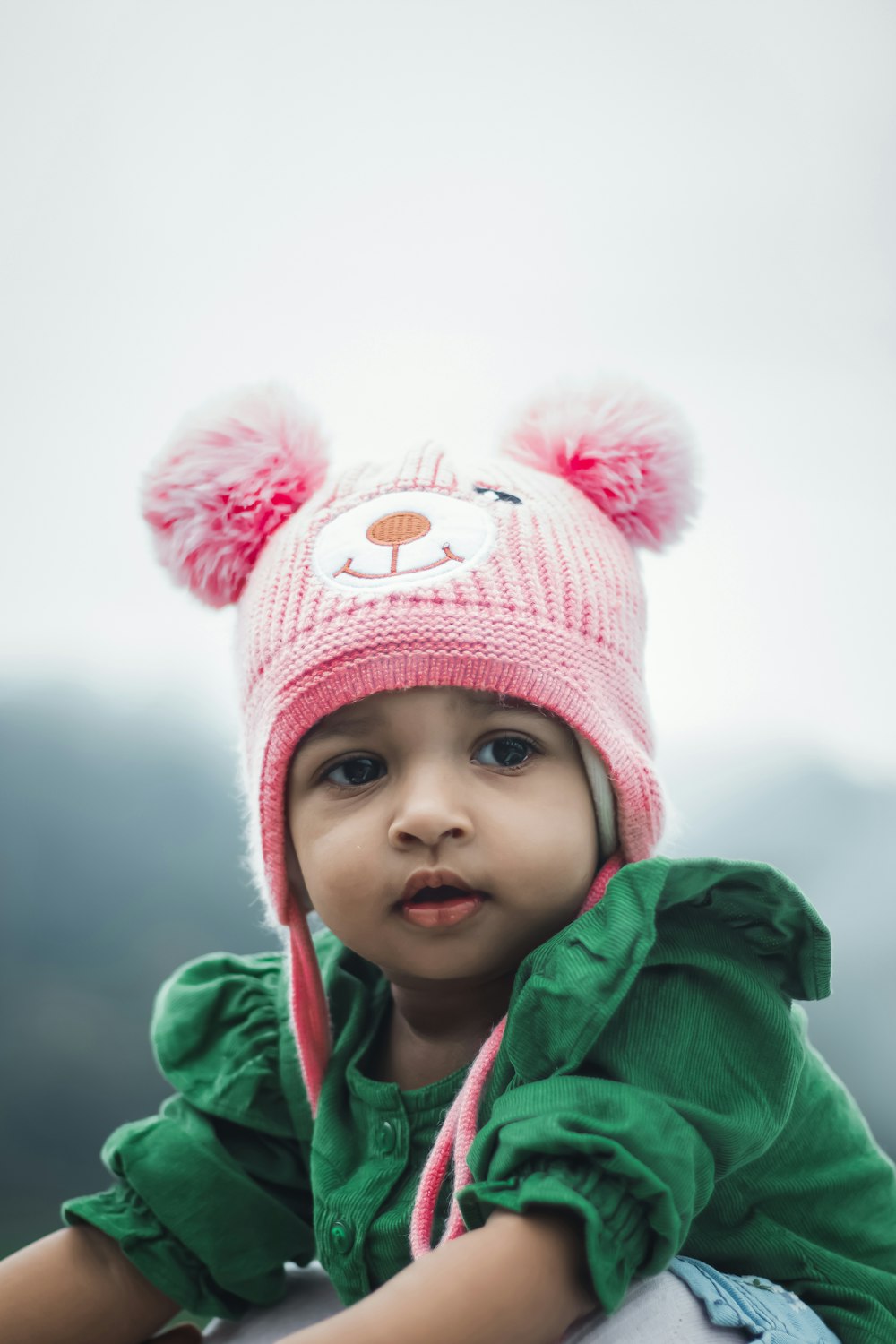 a baby wearing a pink hat