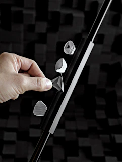 Technician inspecting a prism under bright, focused lighting in a modern laboratory