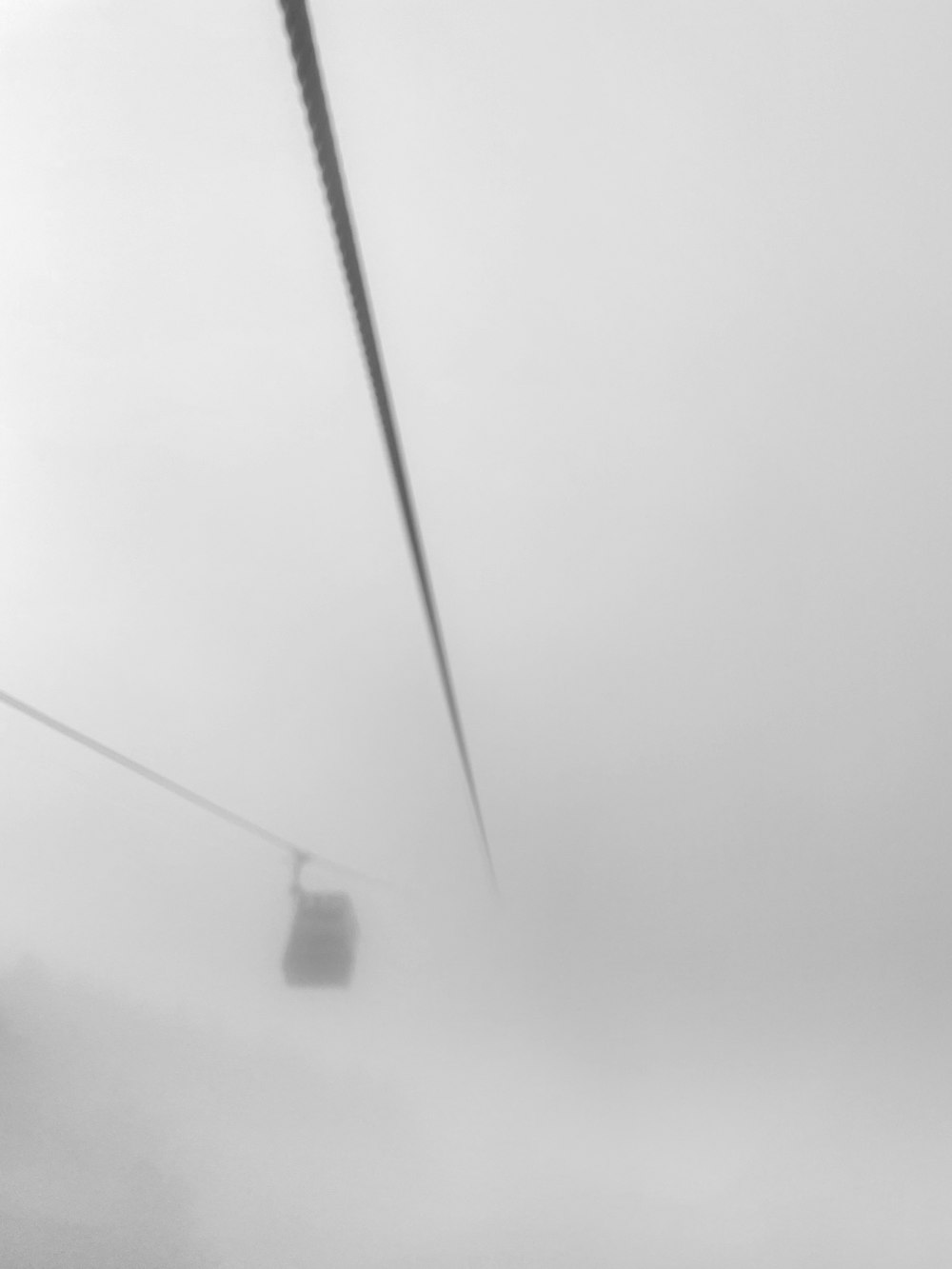 a black and white photo of a power line