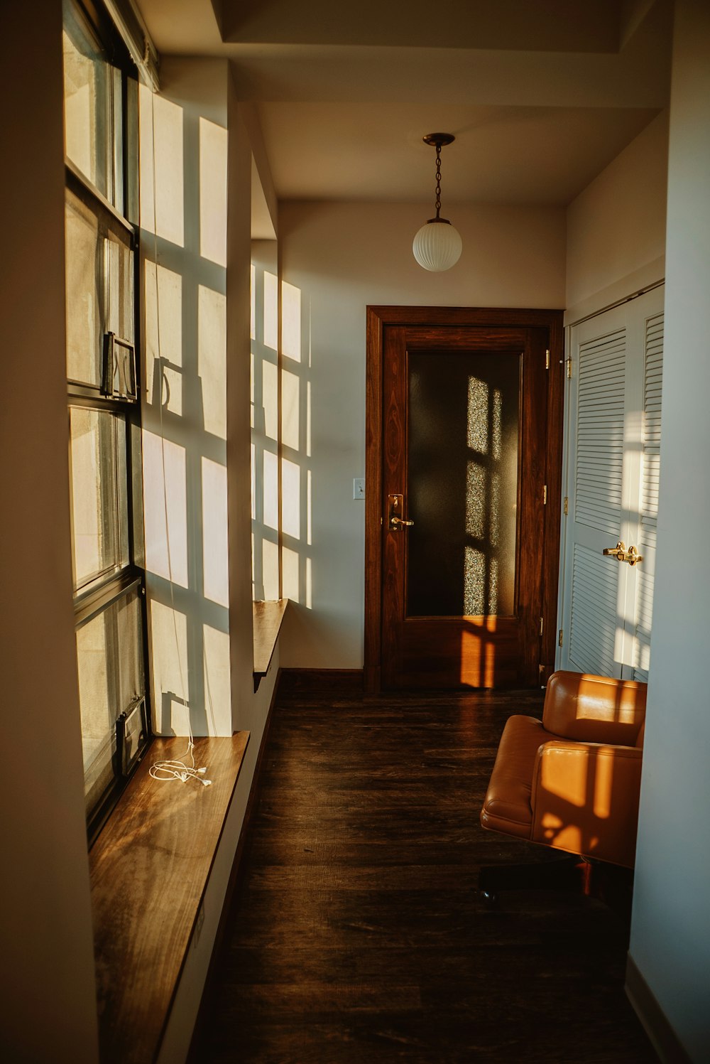 a hallway with a chair and a door