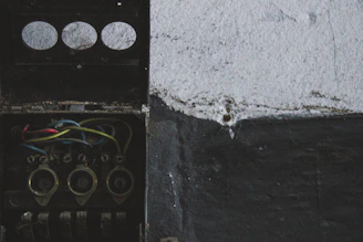 Close-up of hands connecting wires inside an electrical box.