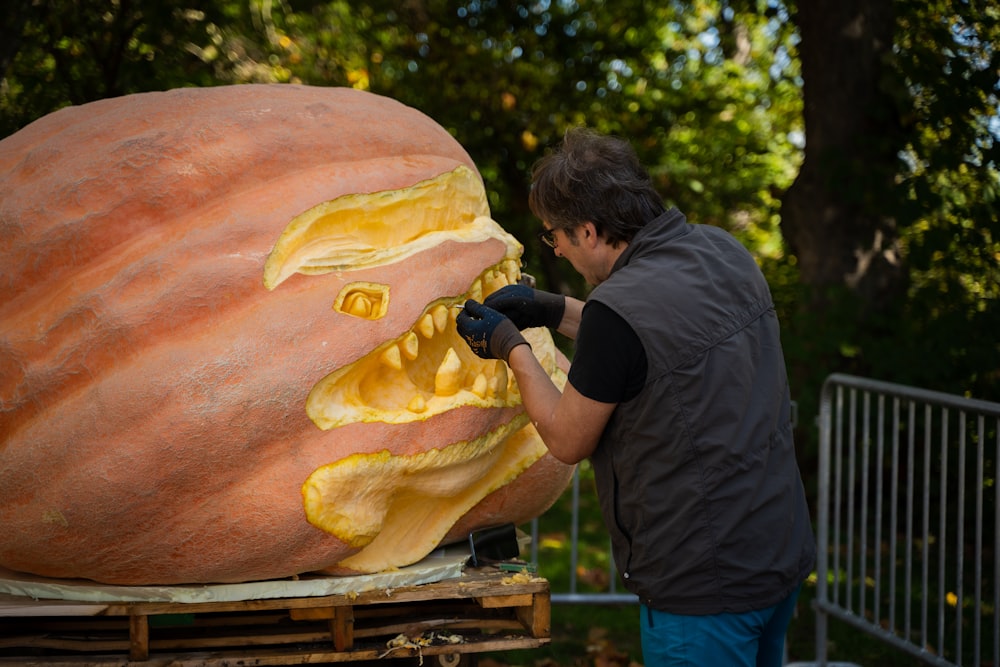 a man carving a pumpkin