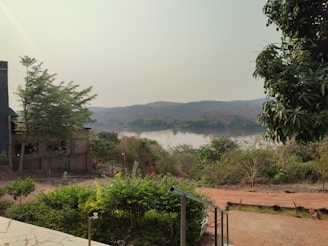 A serene landscape with a river and pumping station in the background.