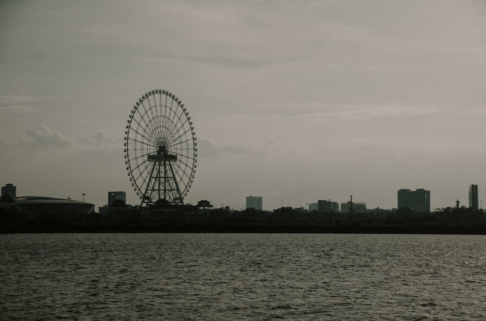 a ferris wheel by a body of water