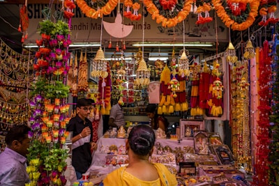 A vibrant market stall decorated with colorful banners showcasing special event promotions.