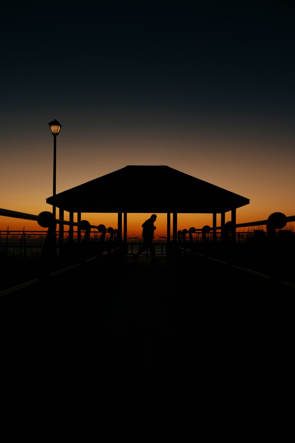 a person stands under an umbrella at the beach