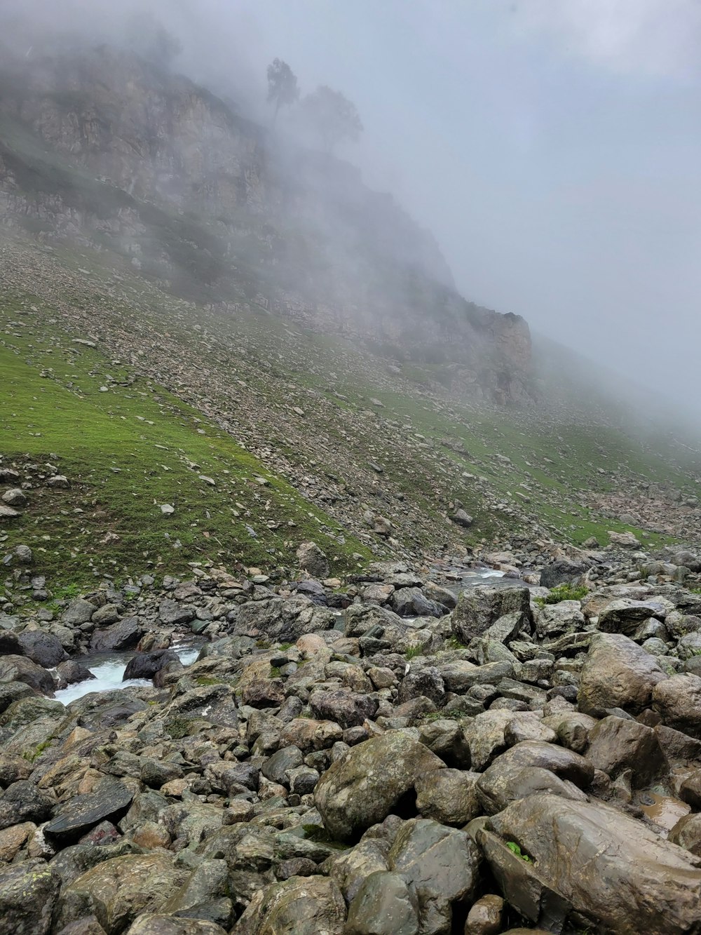 a rocky area with a foggy sky above