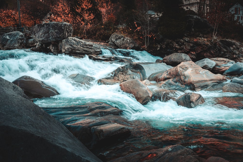 a river with rocks and a waterfall