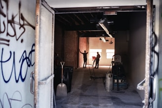 a group of people walking through an alleyway