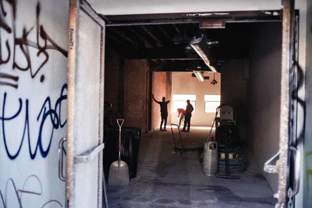 a group of people walking through an alleyway