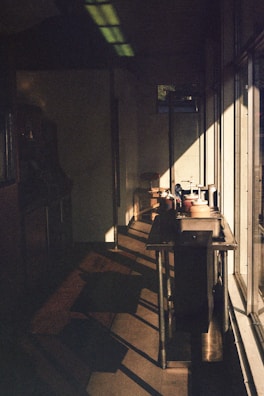 Natural light casting shadows over a terrazzo industrial style table with decorative objects.