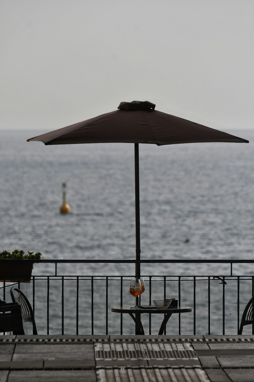 a table and umbrella on a deck
