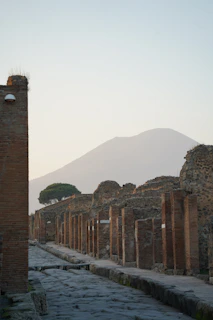 a stone wall with a mountain in the background
