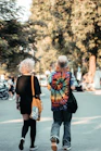 two people walking on a street