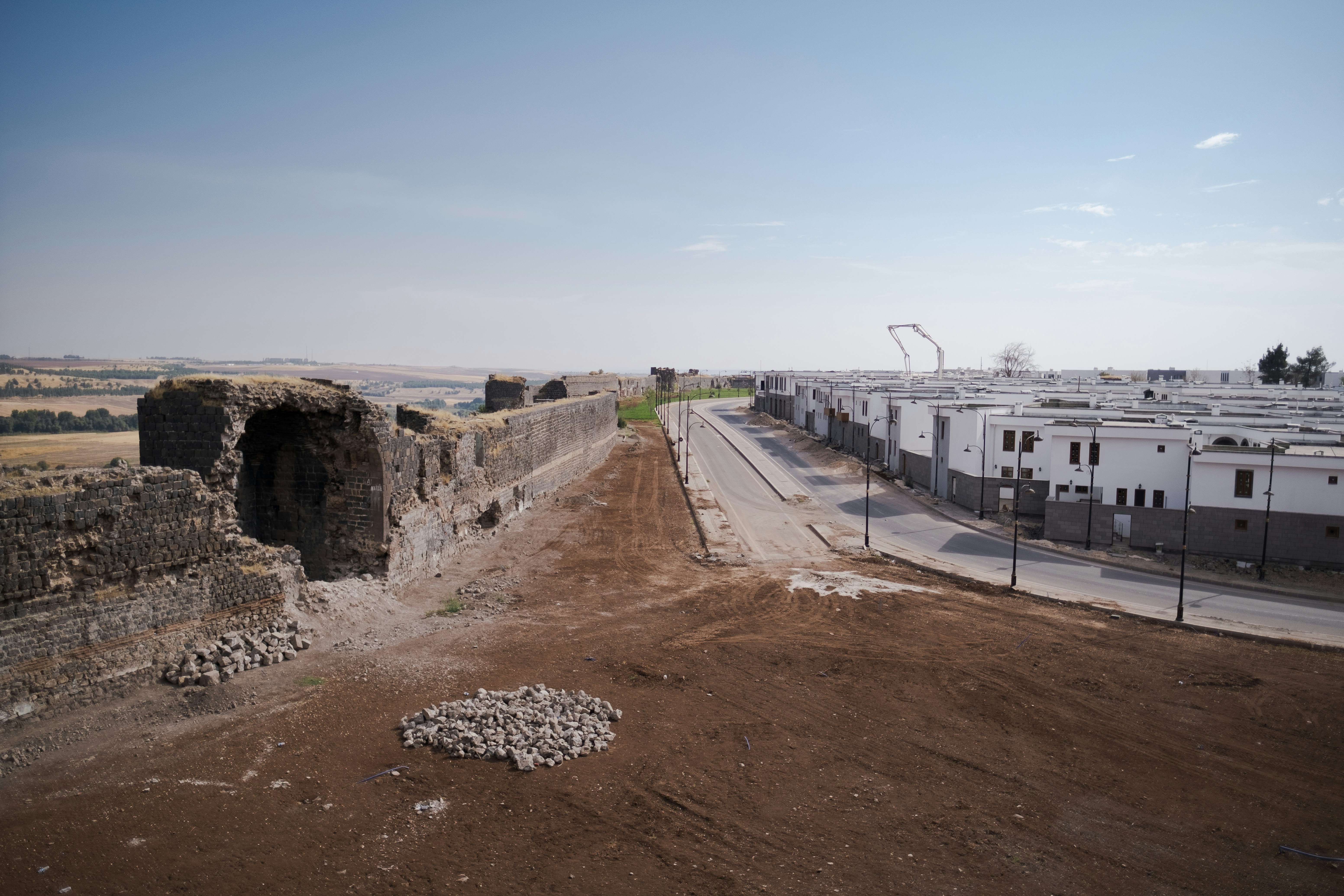 a road with a building on the side, Around the ancient city walls of Diyarbakir.