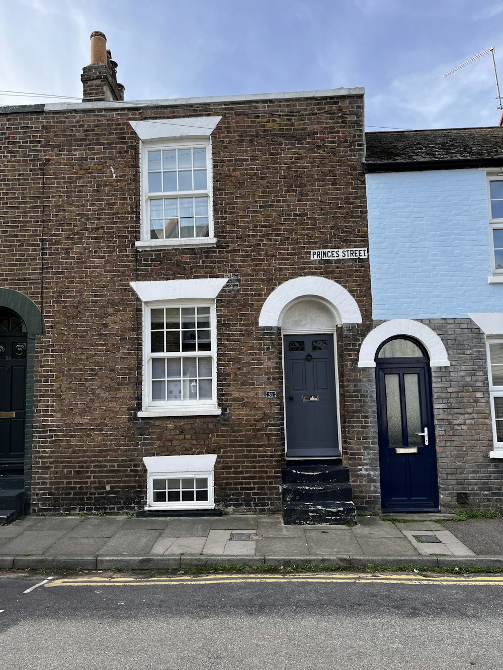 a brick building with blue doors