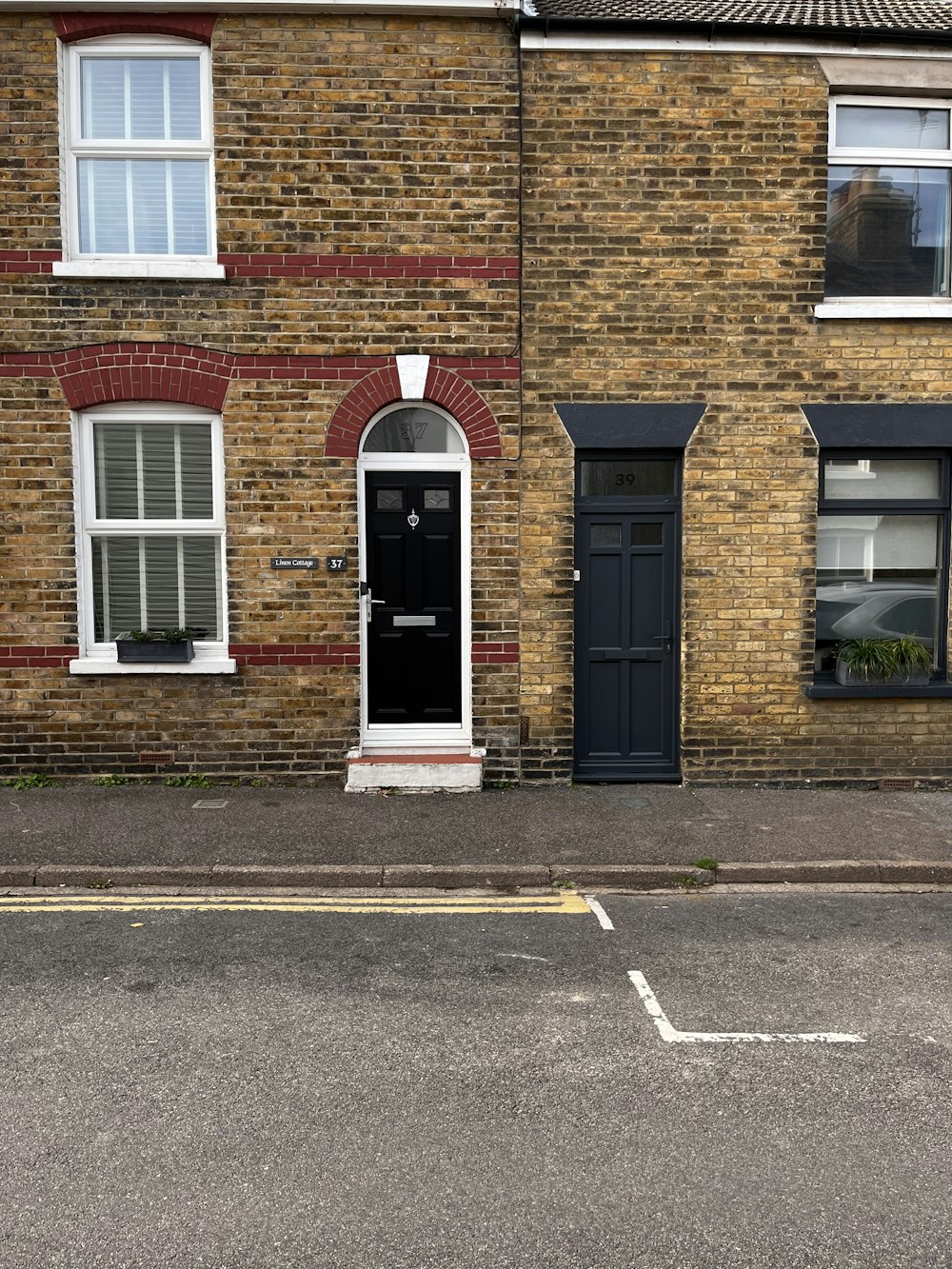 a brick building with a black door