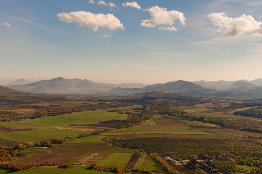 a landscape with hills and buildings