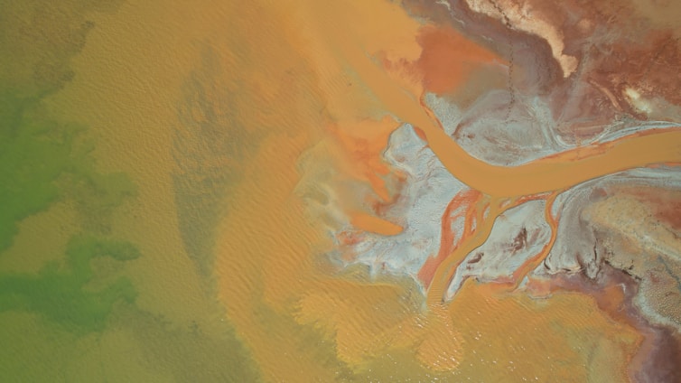 Aerial view of a vibrant landscape showcasing abstract patterns and colors.
