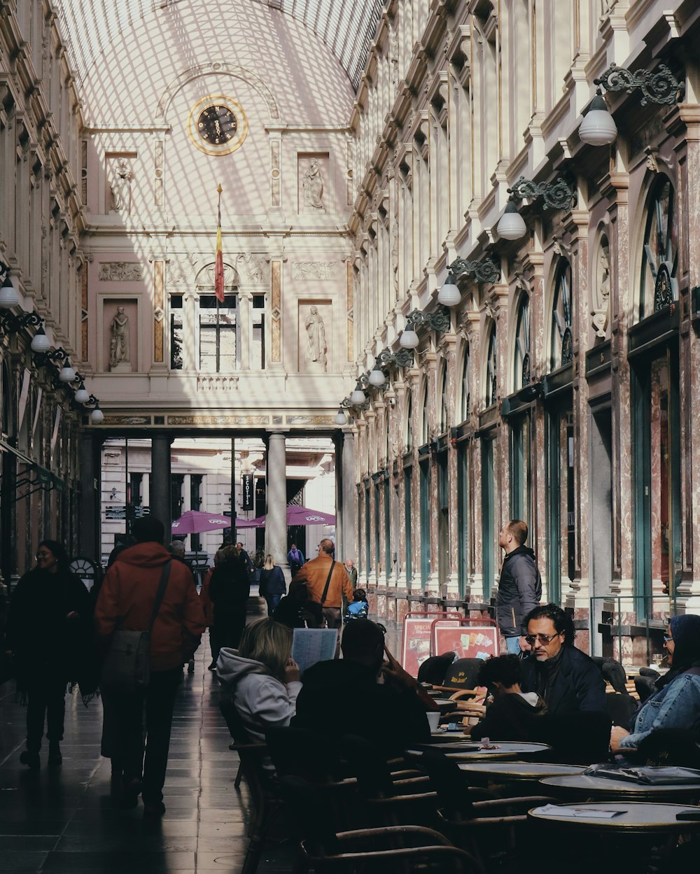 people sitting at tables in a large building