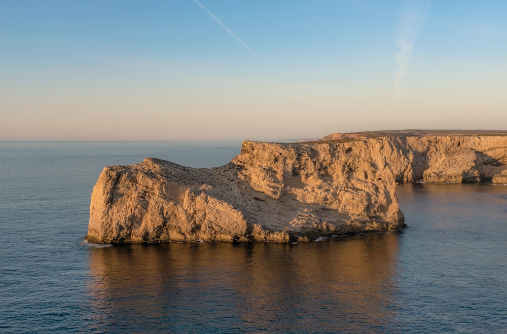 a rocky cliff in the water