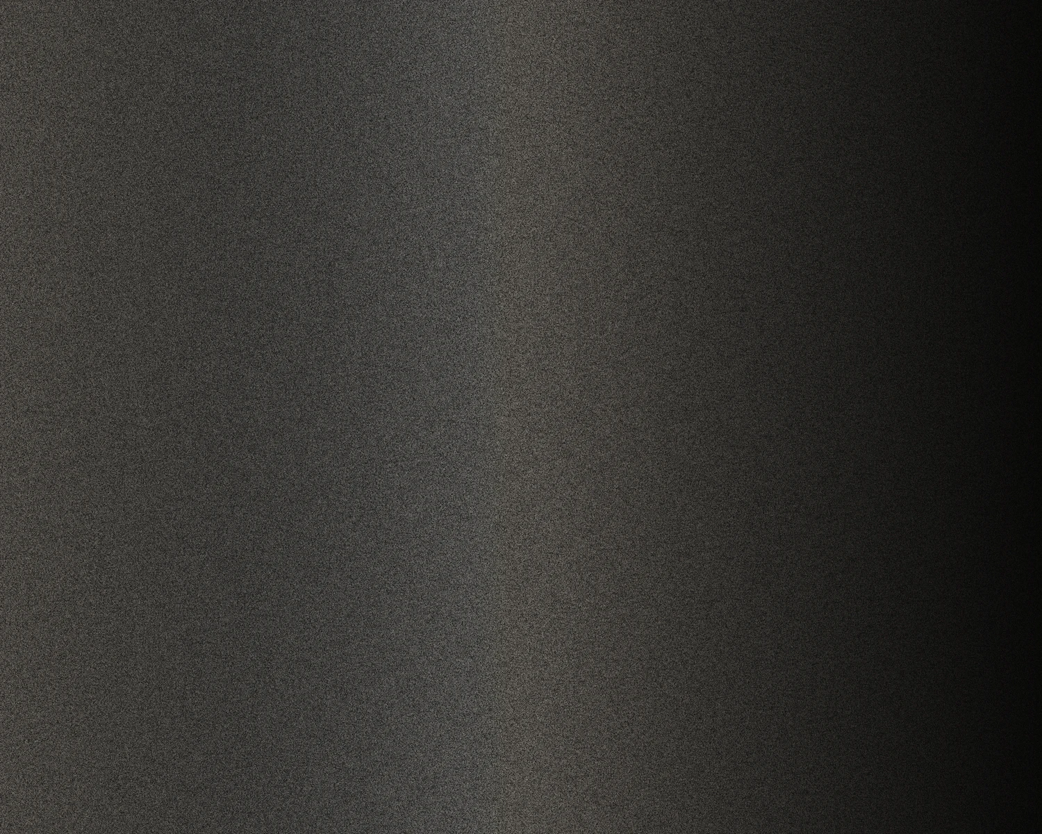 A dark grey anodised surface raking across a soft highlight