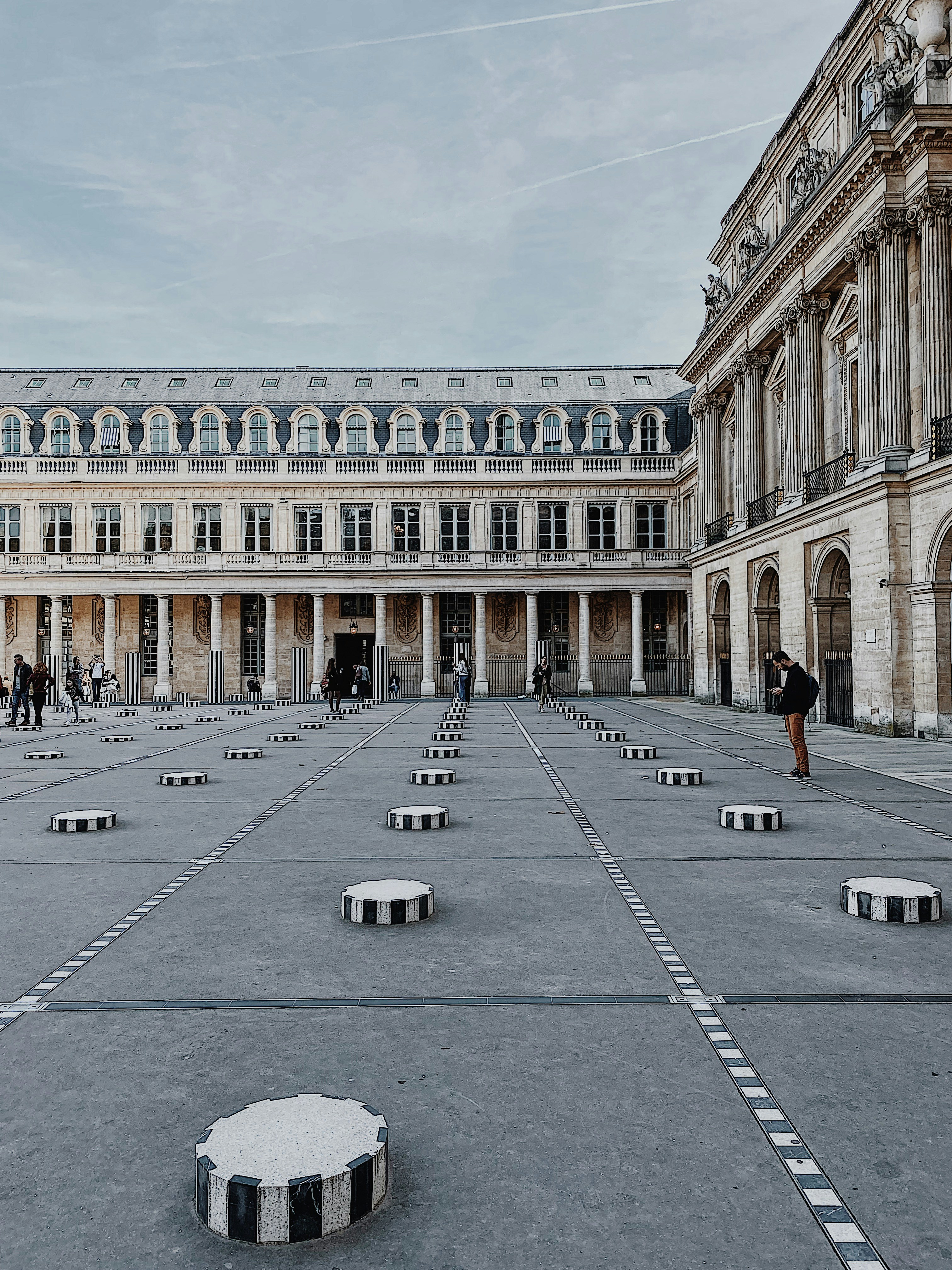a courtyard with benches and people in it