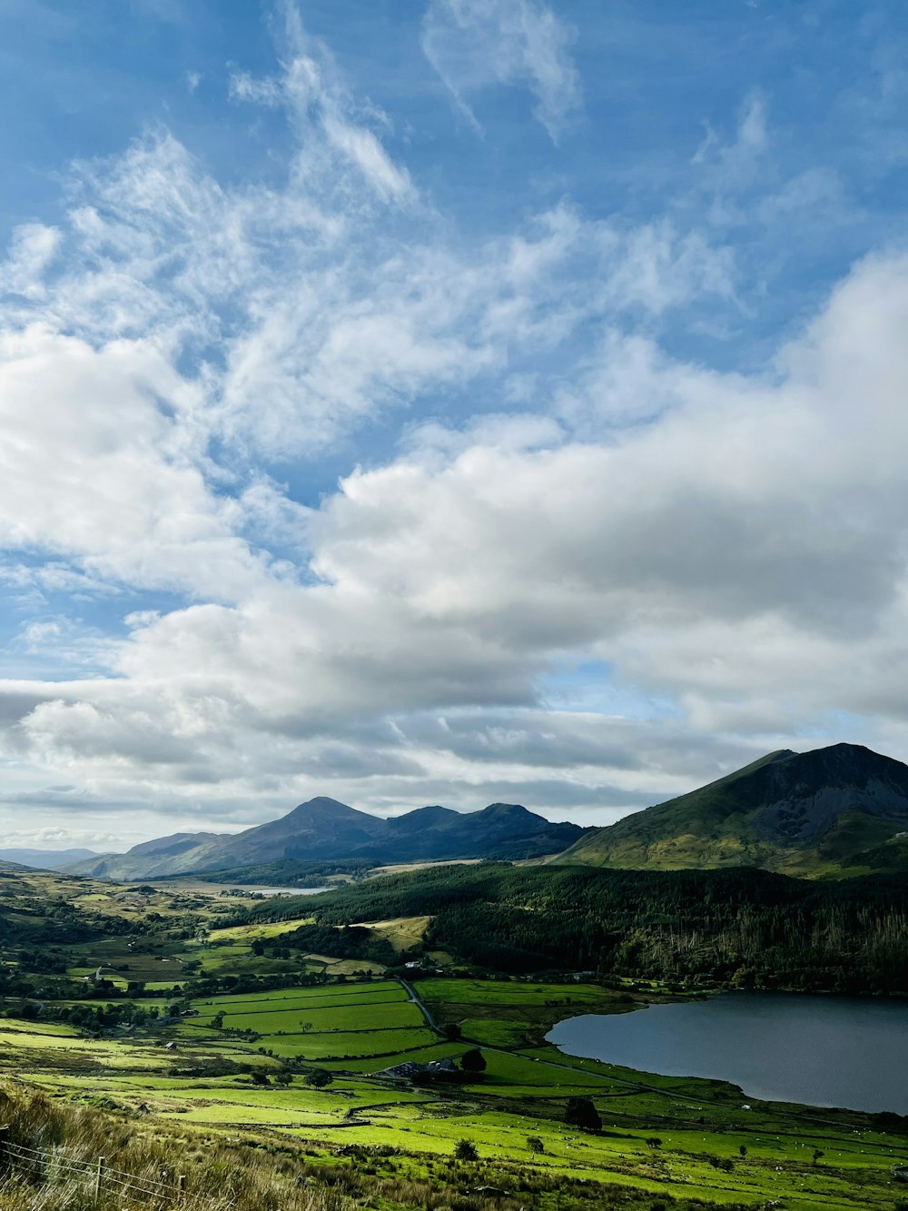 a landscape with hills and a body of water