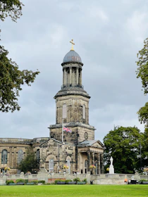 a large building with a gold statue on top