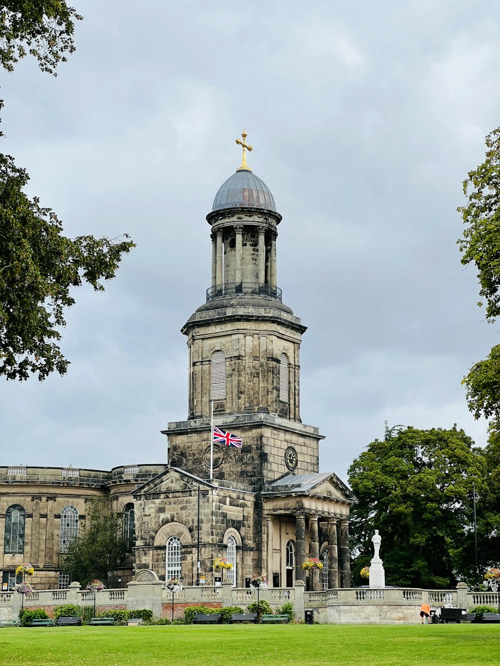 a large building with a gold statue on top