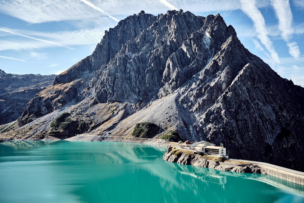 a house on a cliff by a body of water